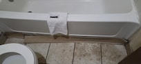 The paneling on the floor is out. Peeling off the bathtub side walls.