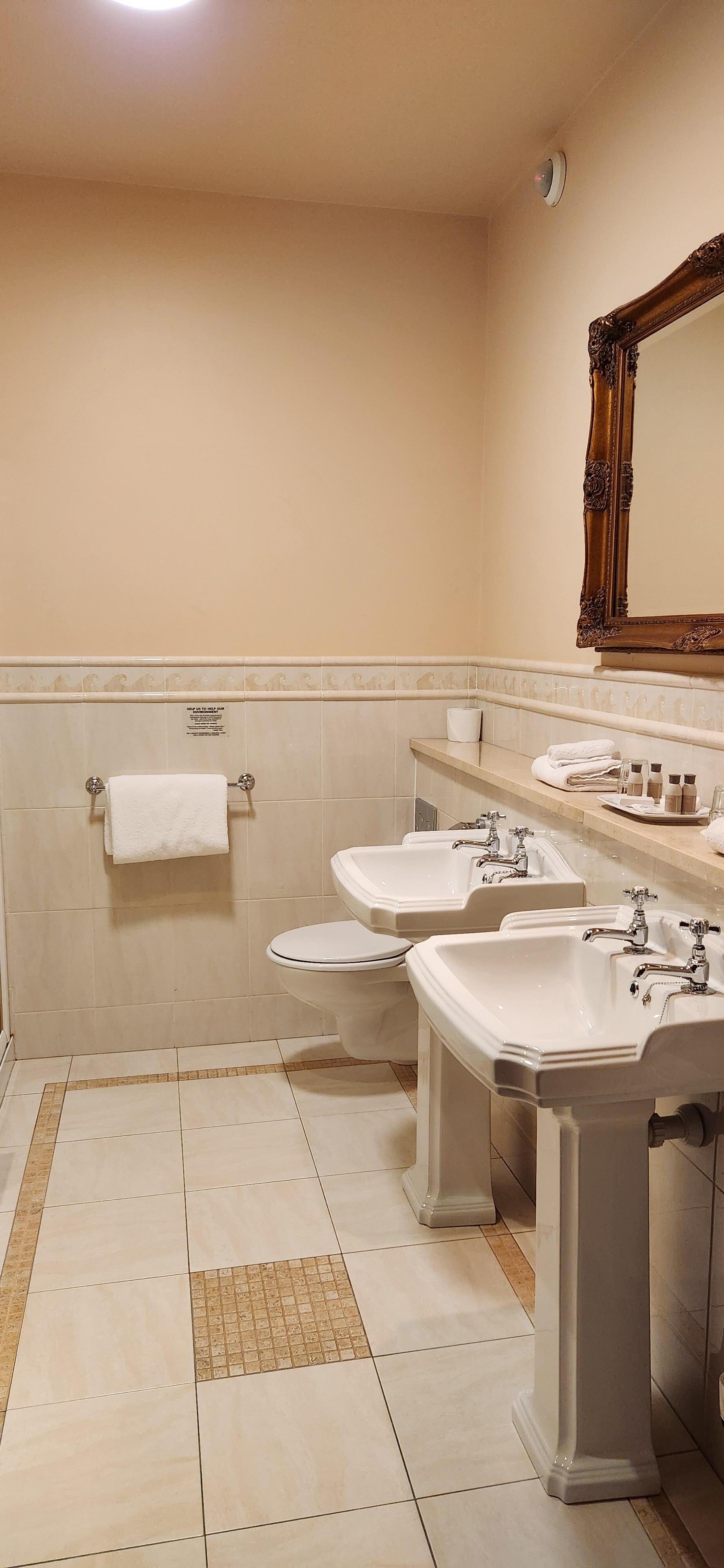 Spacious bathroom, included a walk-in glass walled shower and a large separate tub. 