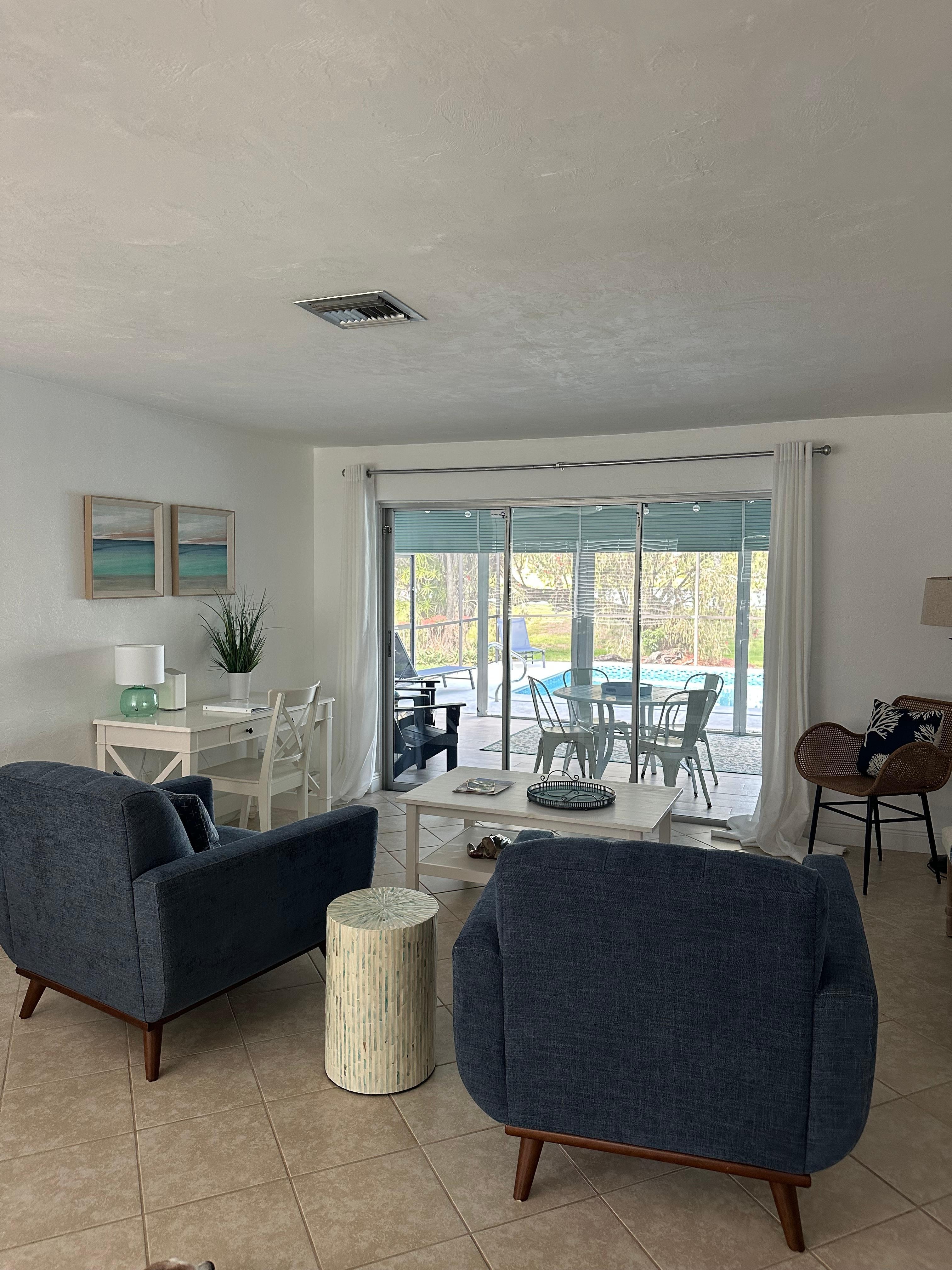 Sitting room with view of pool and beyond