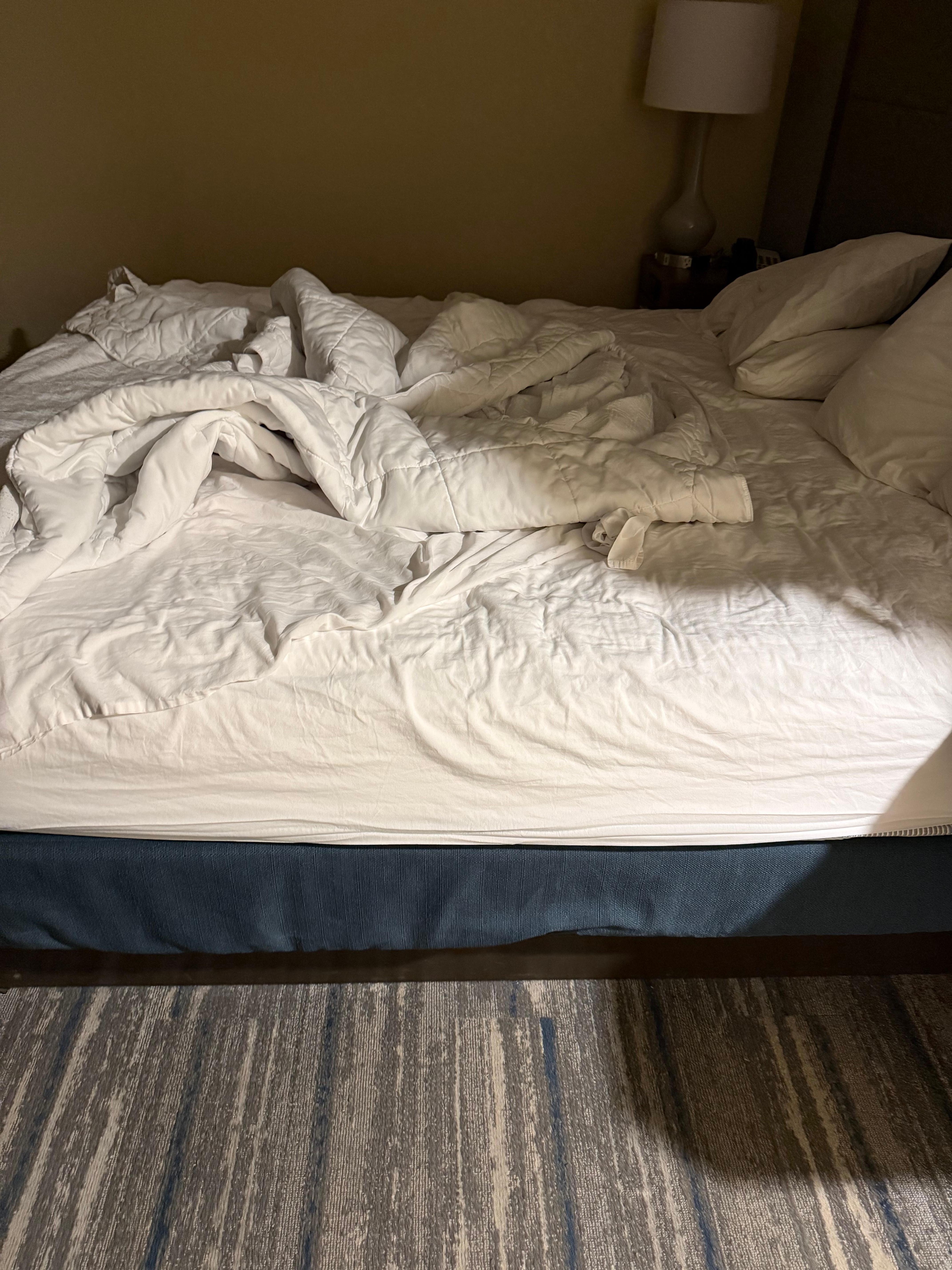 Unmade bed in room first allocated