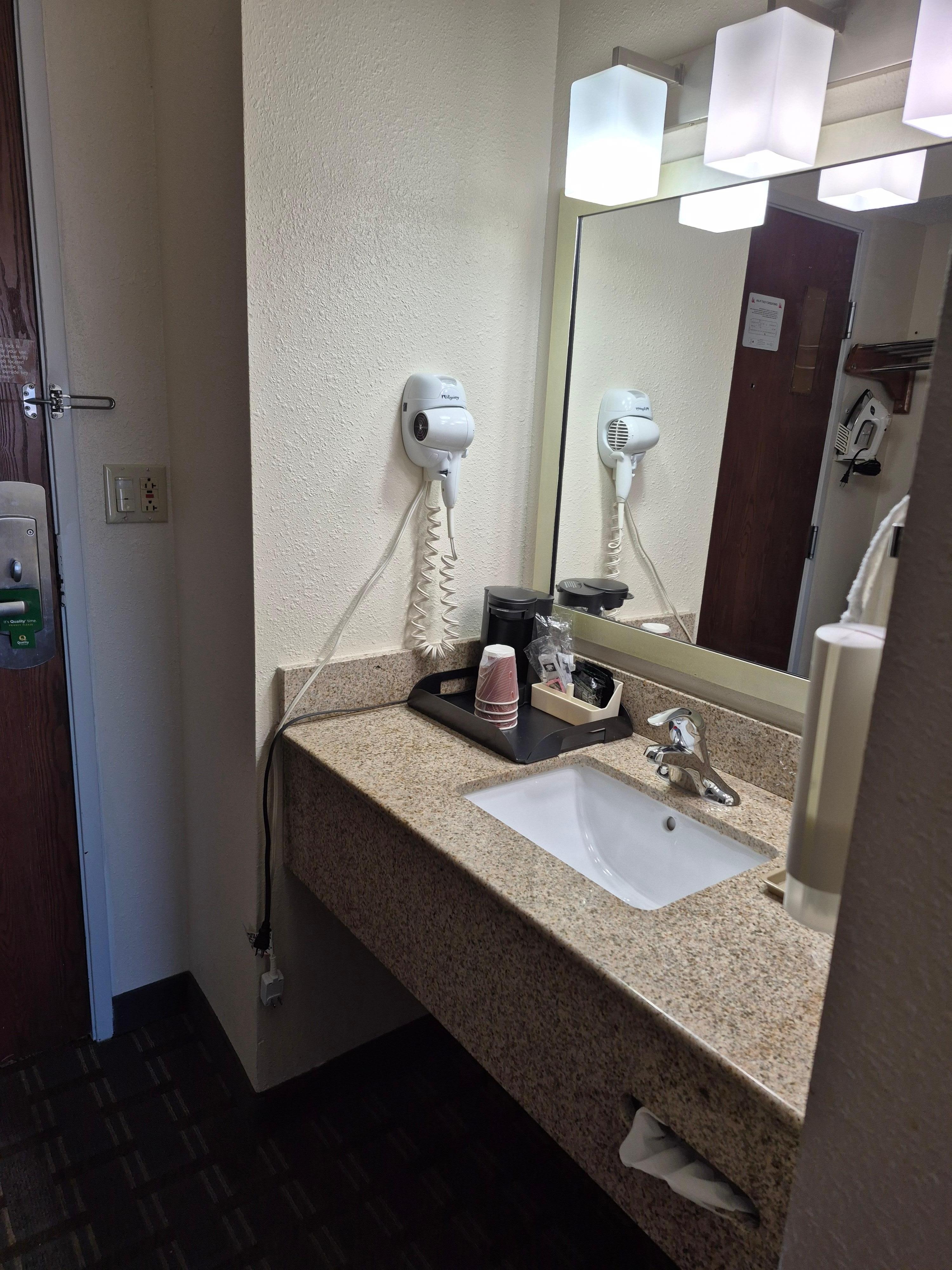 liquid soap mounted here at the sink outside the shower