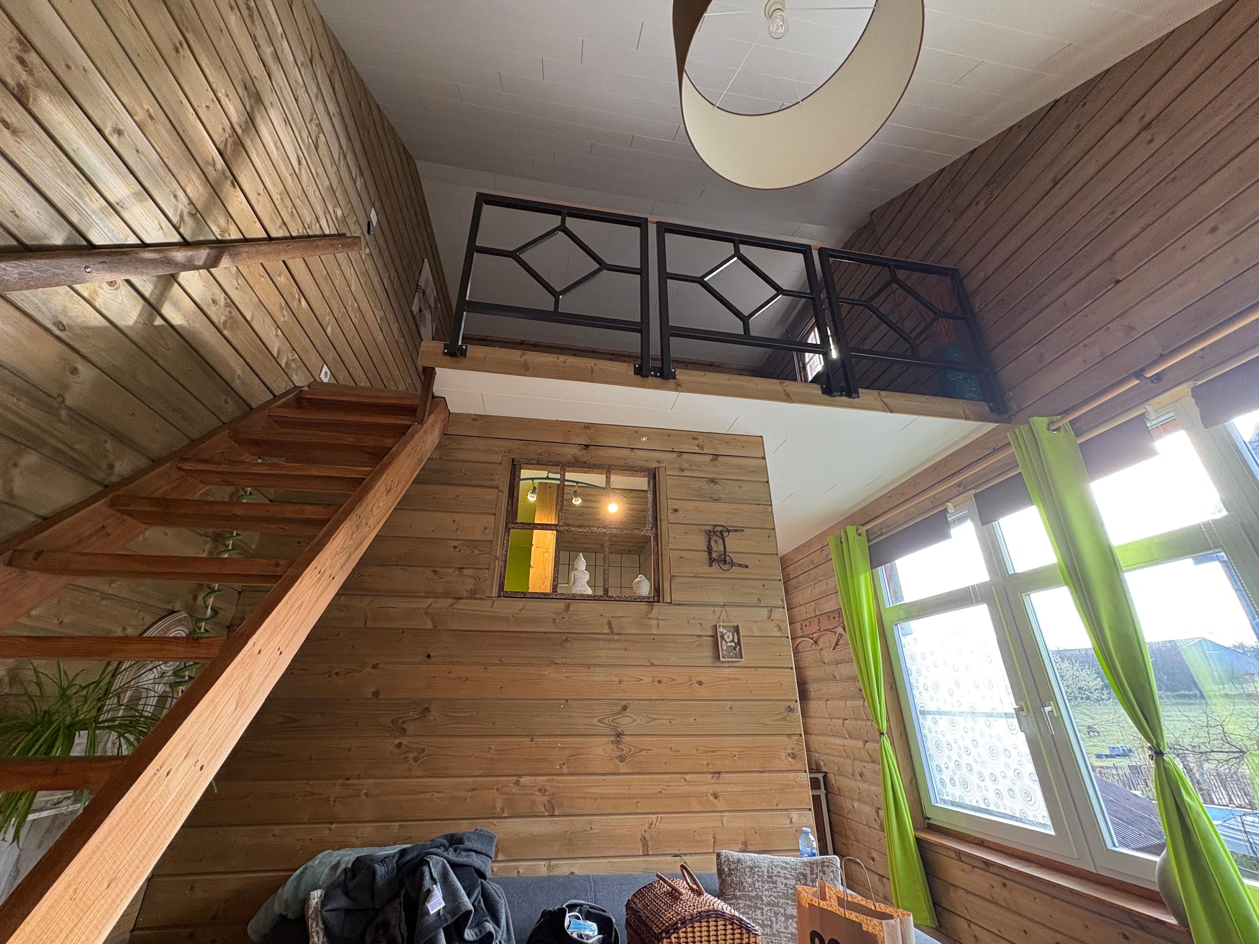 Queen Bed upstairs, couch, bathroom, and kitchen downstairs.