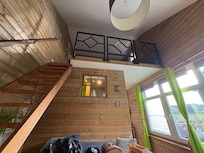 Queen Bed upstairs, couch, bathroom, and kitchen downstairs.