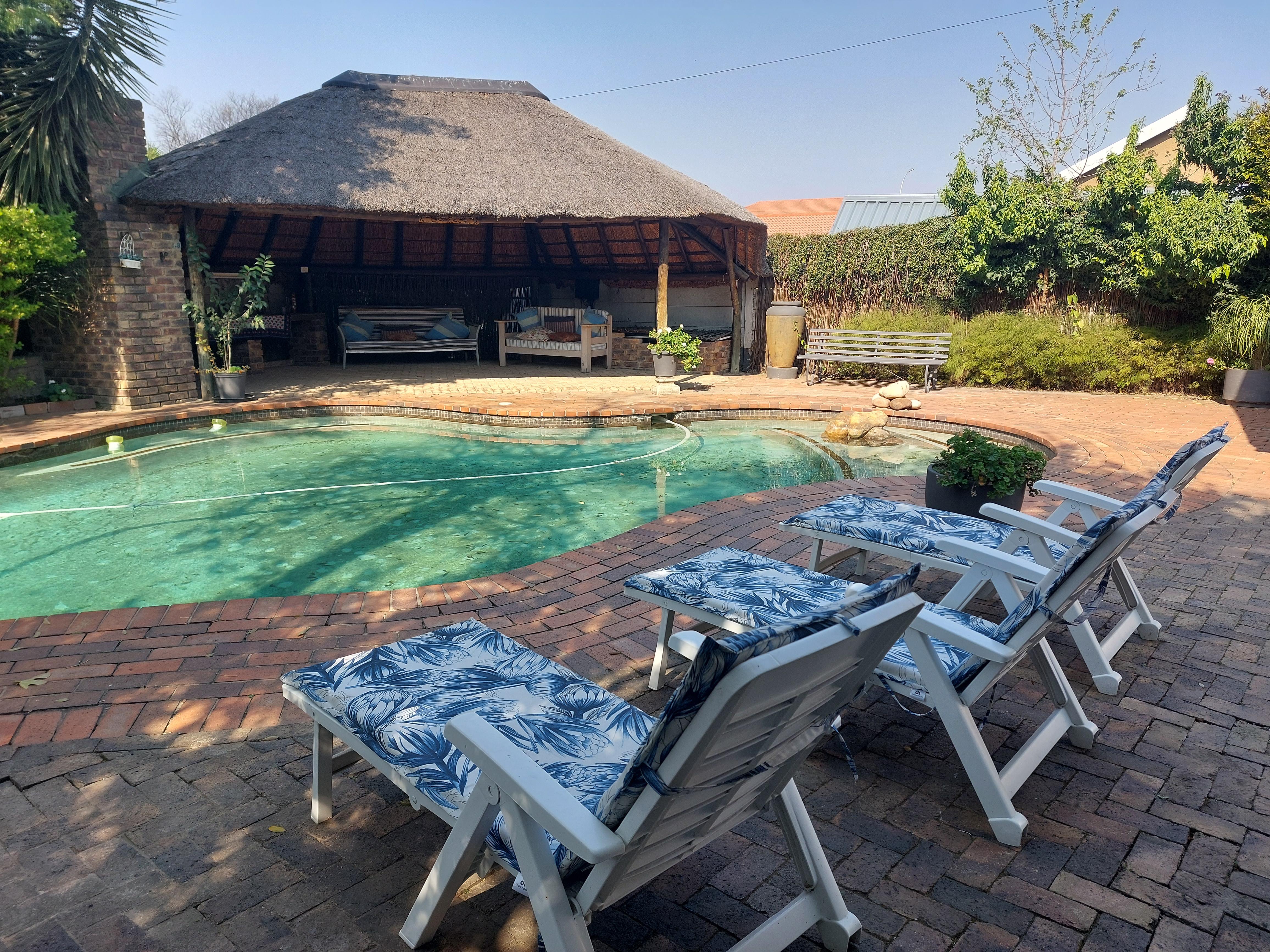 A view of the pool and outdoor eating and sitting area.