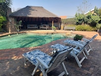 A view of the pool and outdoor eating and sitting area.