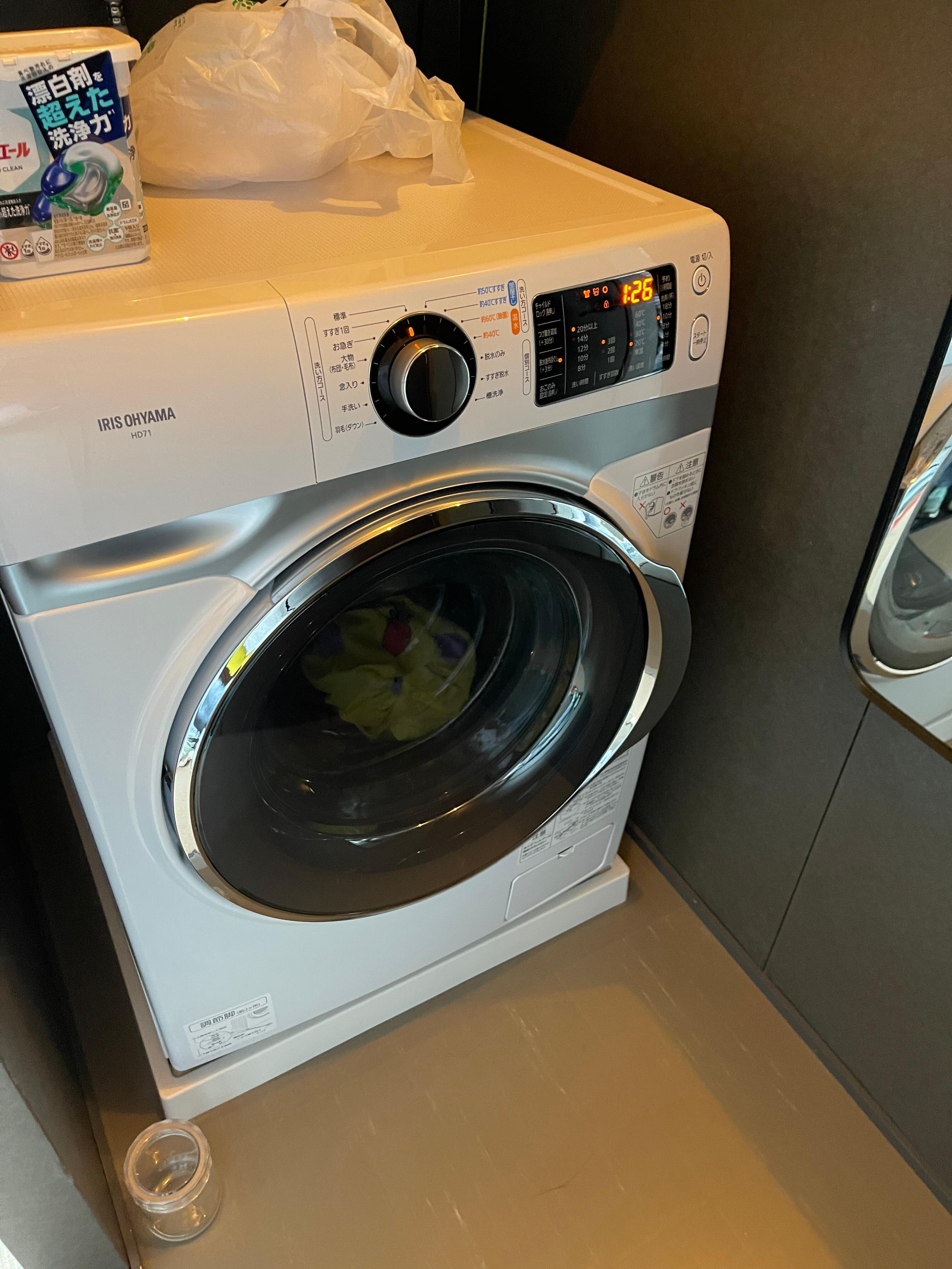 washing machine in front of toilet