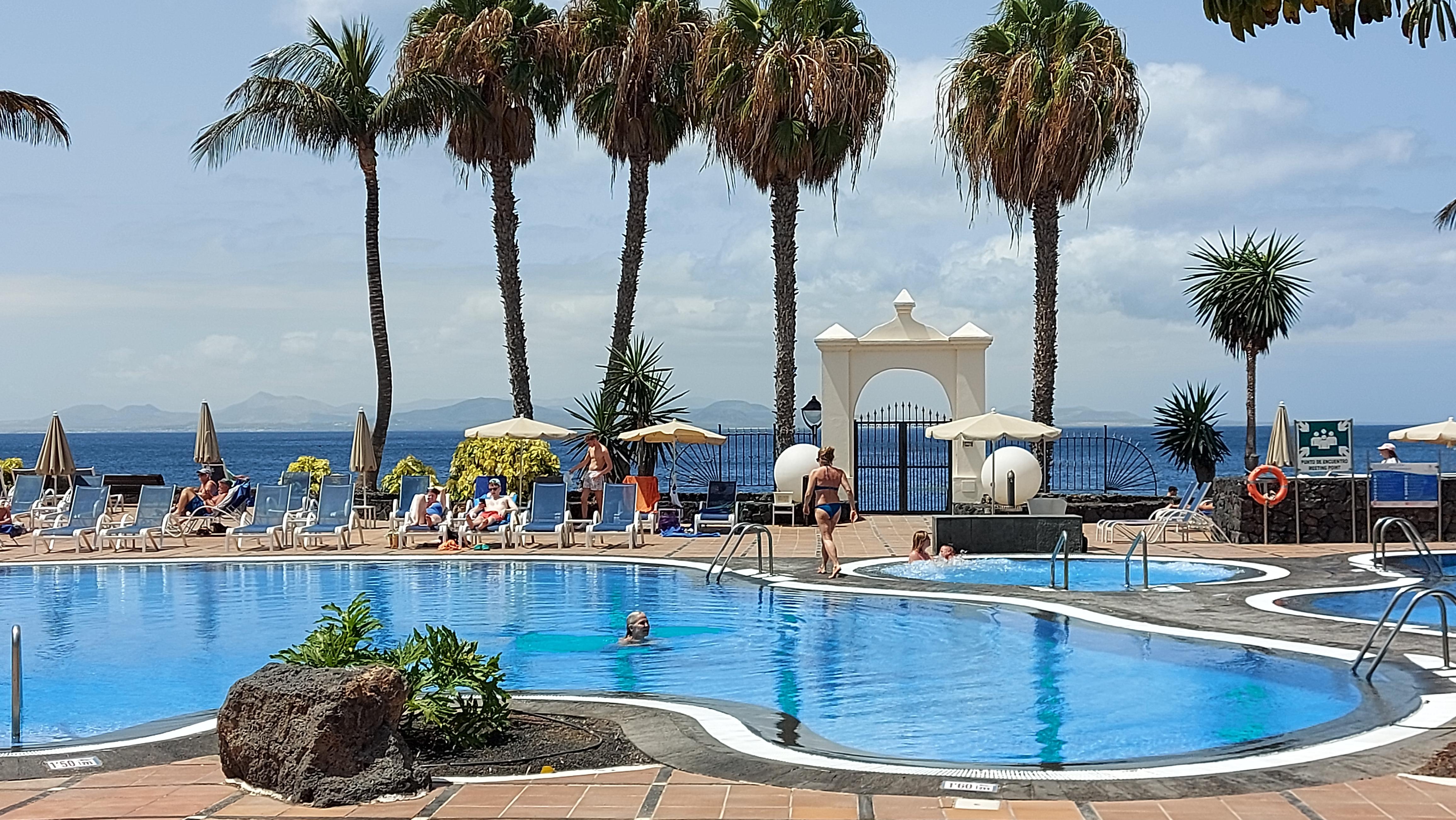 Hotel pool area with view of Fuerteventura in the distance