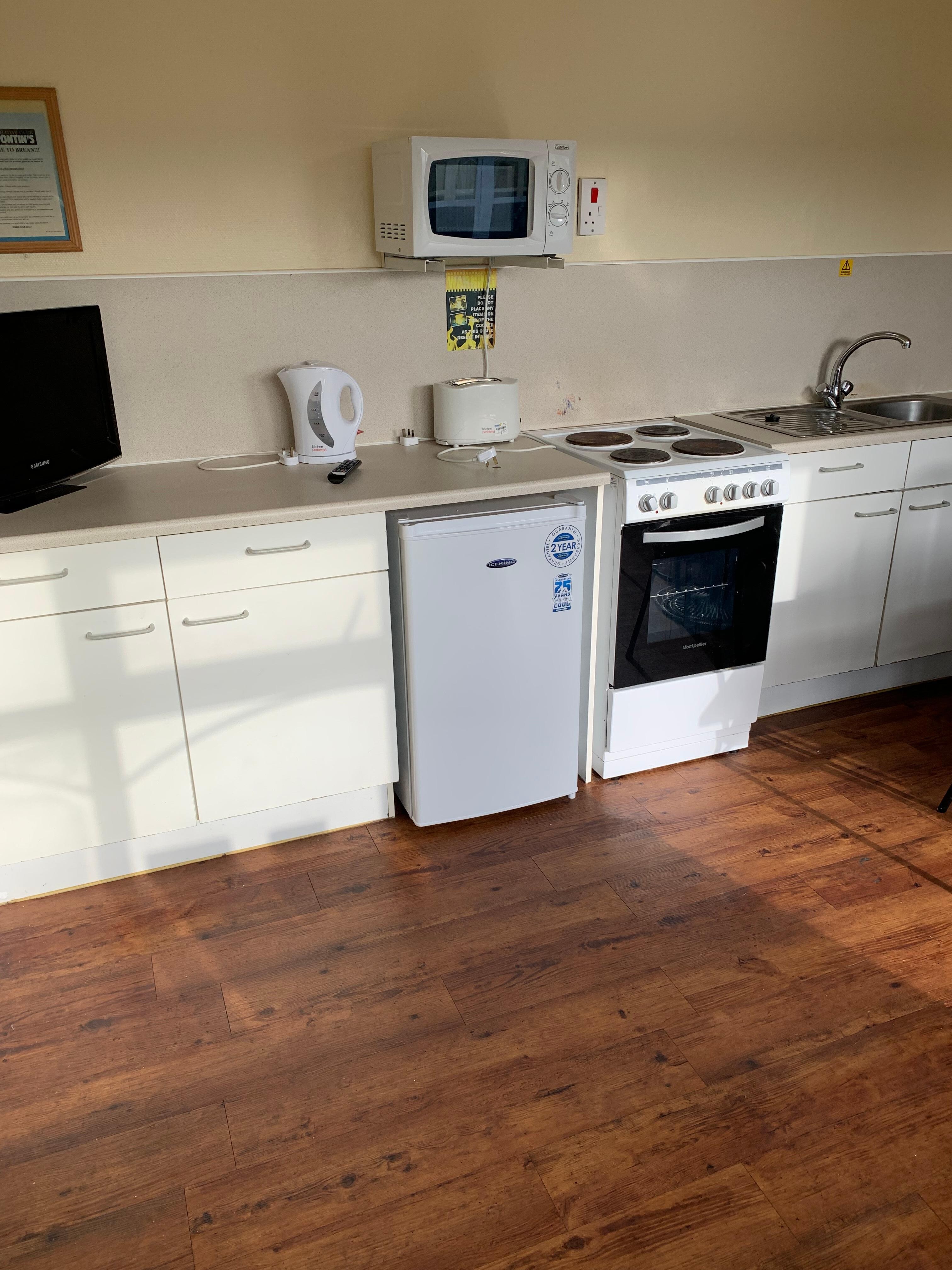 The kitchenette with no cups spoons. Fridge was clean. 