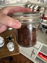 Pot of instant coffee comprised of mixture of dregs from jars