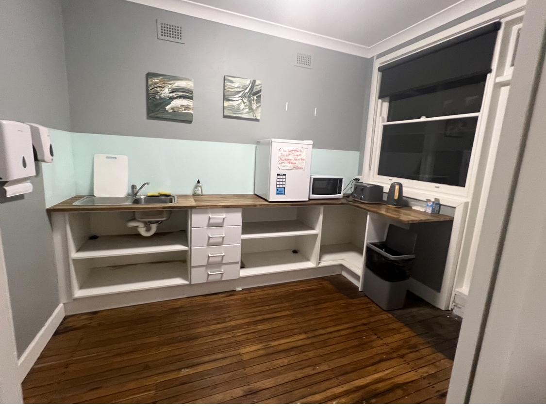 Shared Kitchen was aged with visible grime, waterstains and cockroach baits 