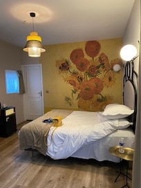 The bedroom with reproduction on the wall of Van Gogh’s sunflowers