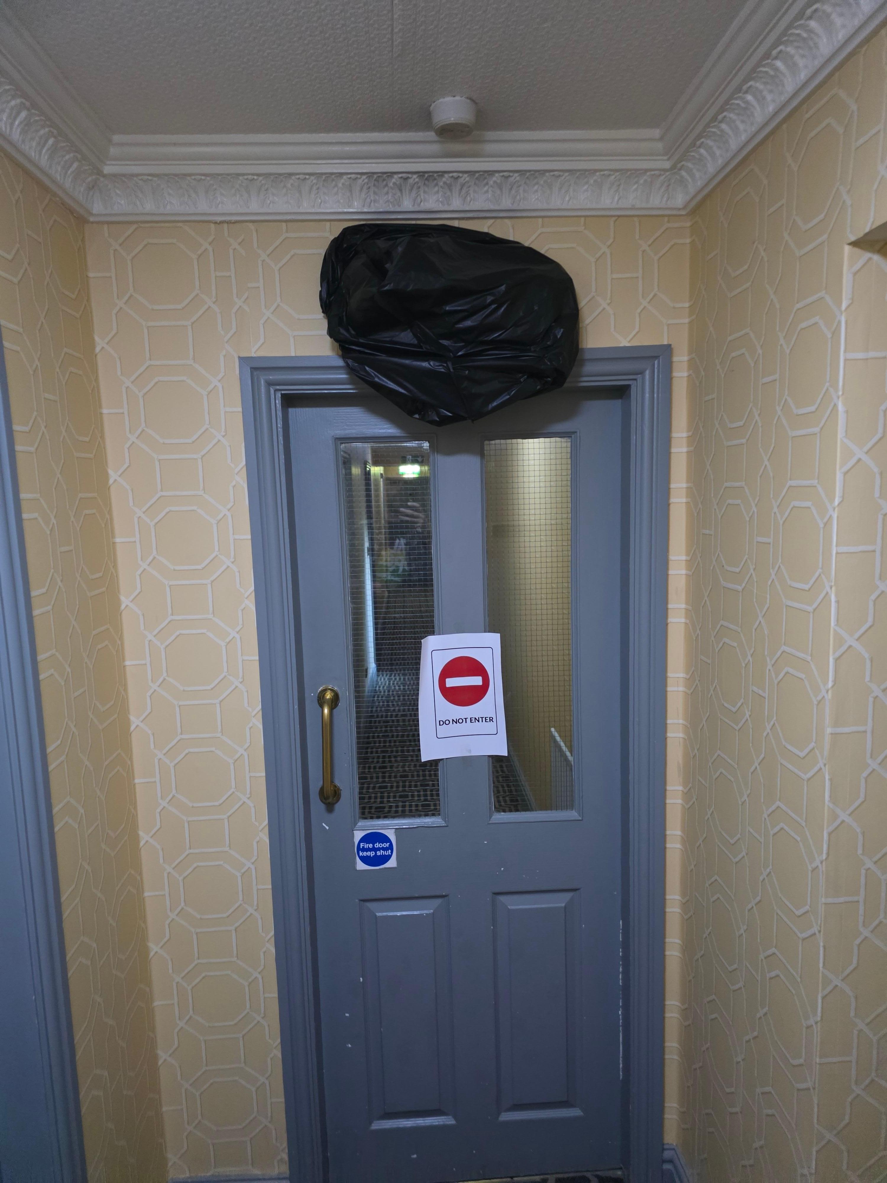 Covered fire escape sign and closed section of hotel due to the refurb