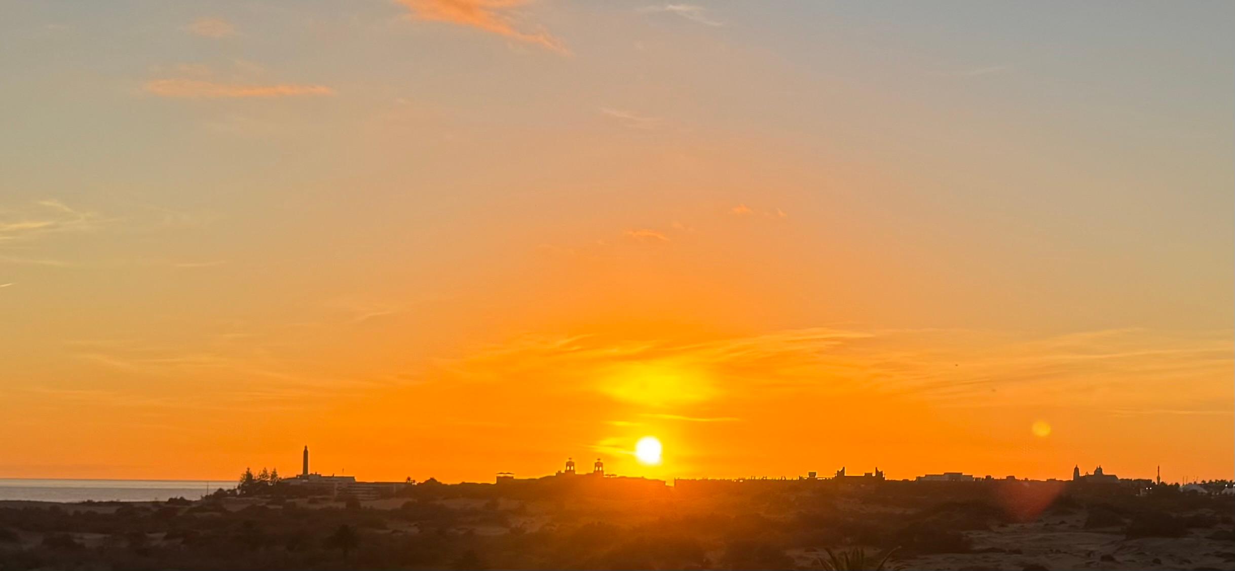 Sunset over  Meloneras in the distance