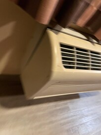 Broken heater hanging off the wall