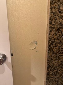 Hole in bathroom wall