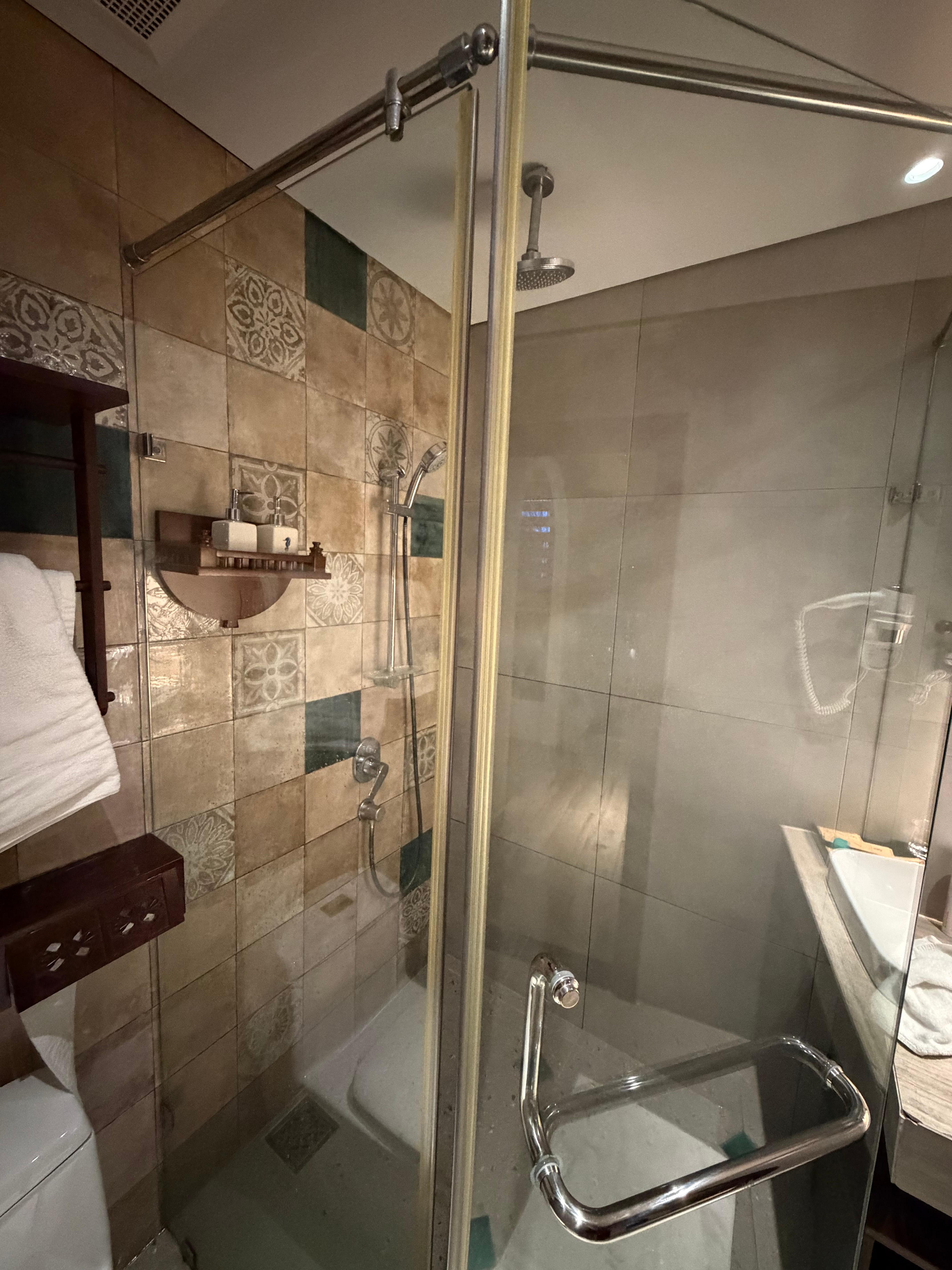 The shower door is broken and cannot be closed.