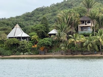 View of the property from the boat. The middle structure is the treehouse and the left larger metal roof is the main house.