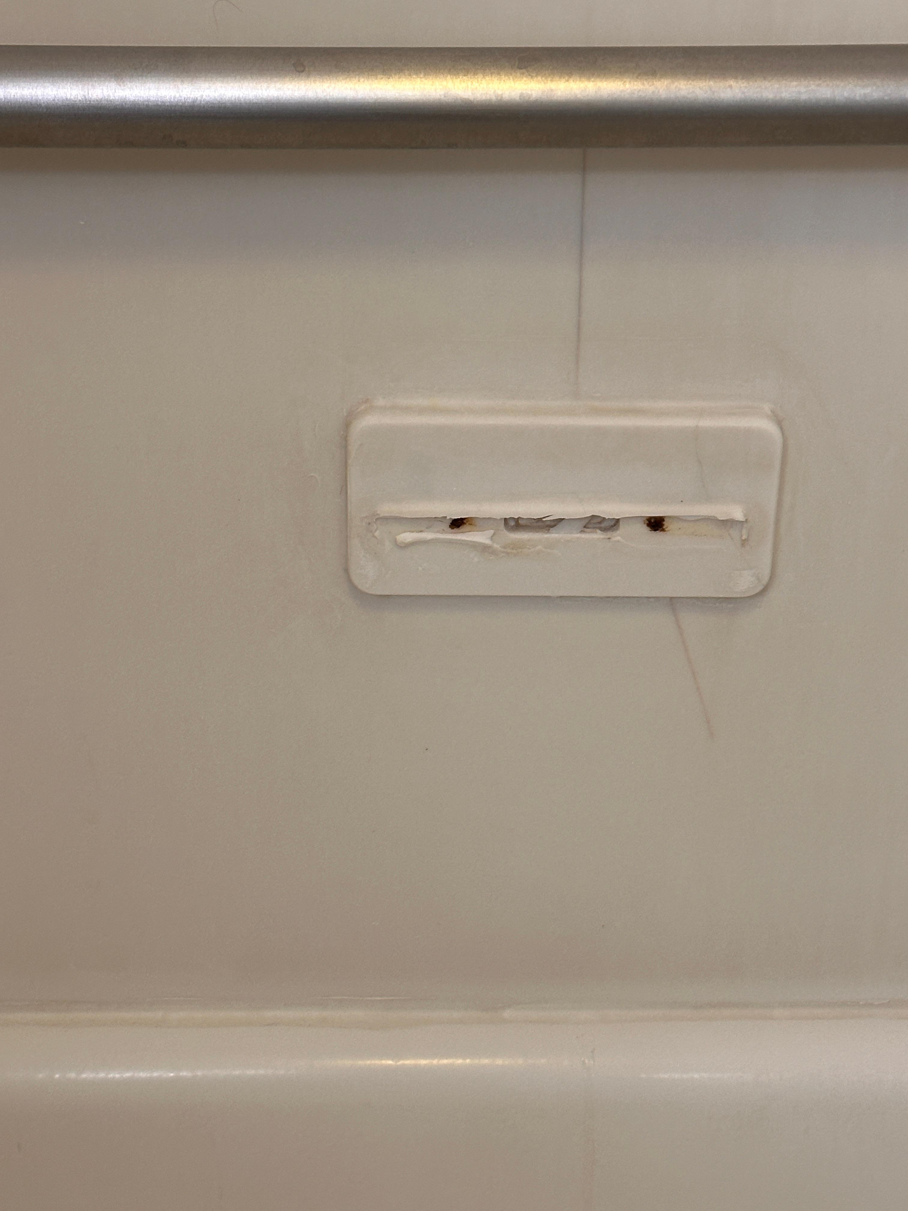 Broken something or other on bathtub wall