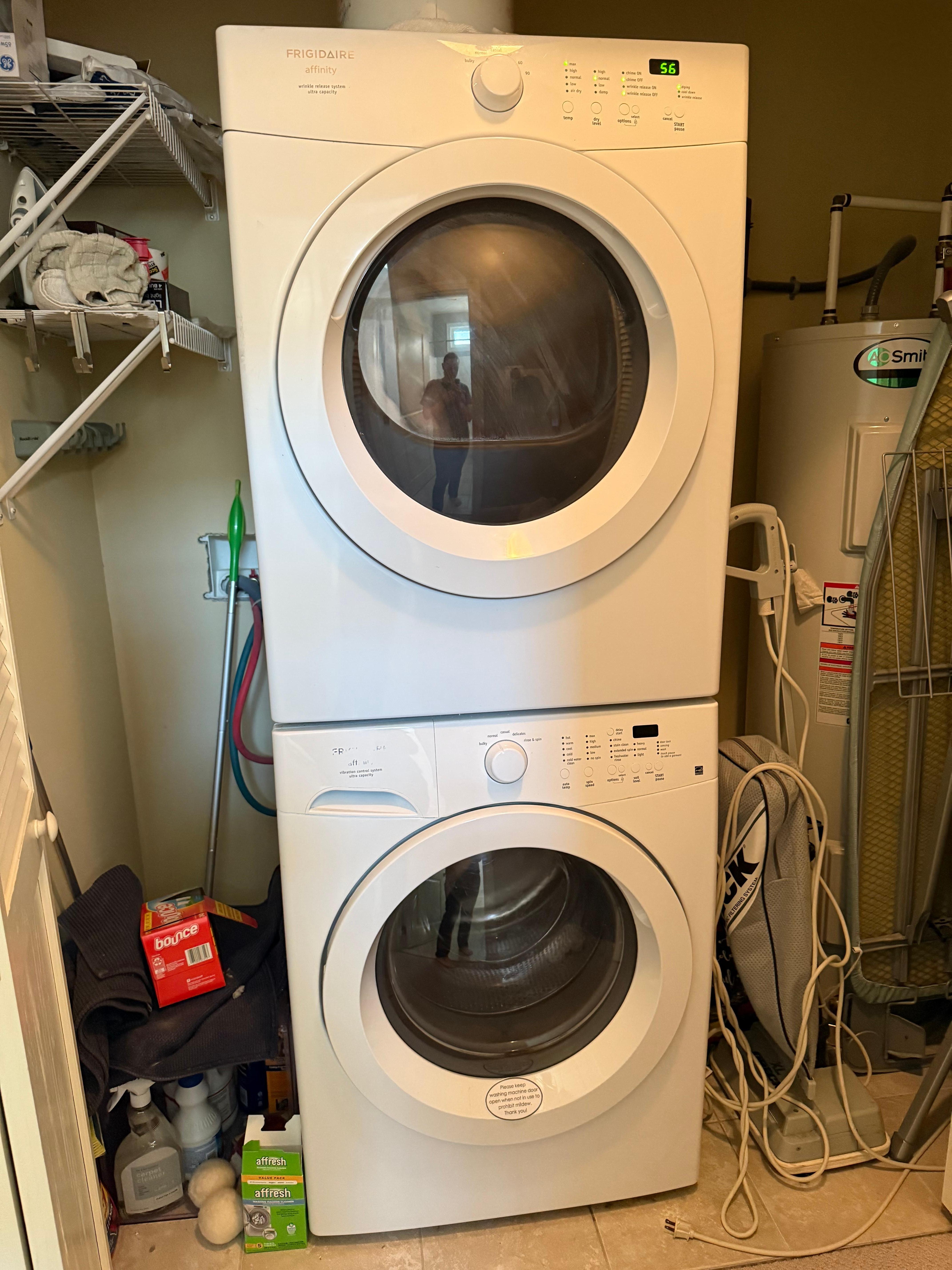 Disorganized laundry closet with dirty bath mats. 