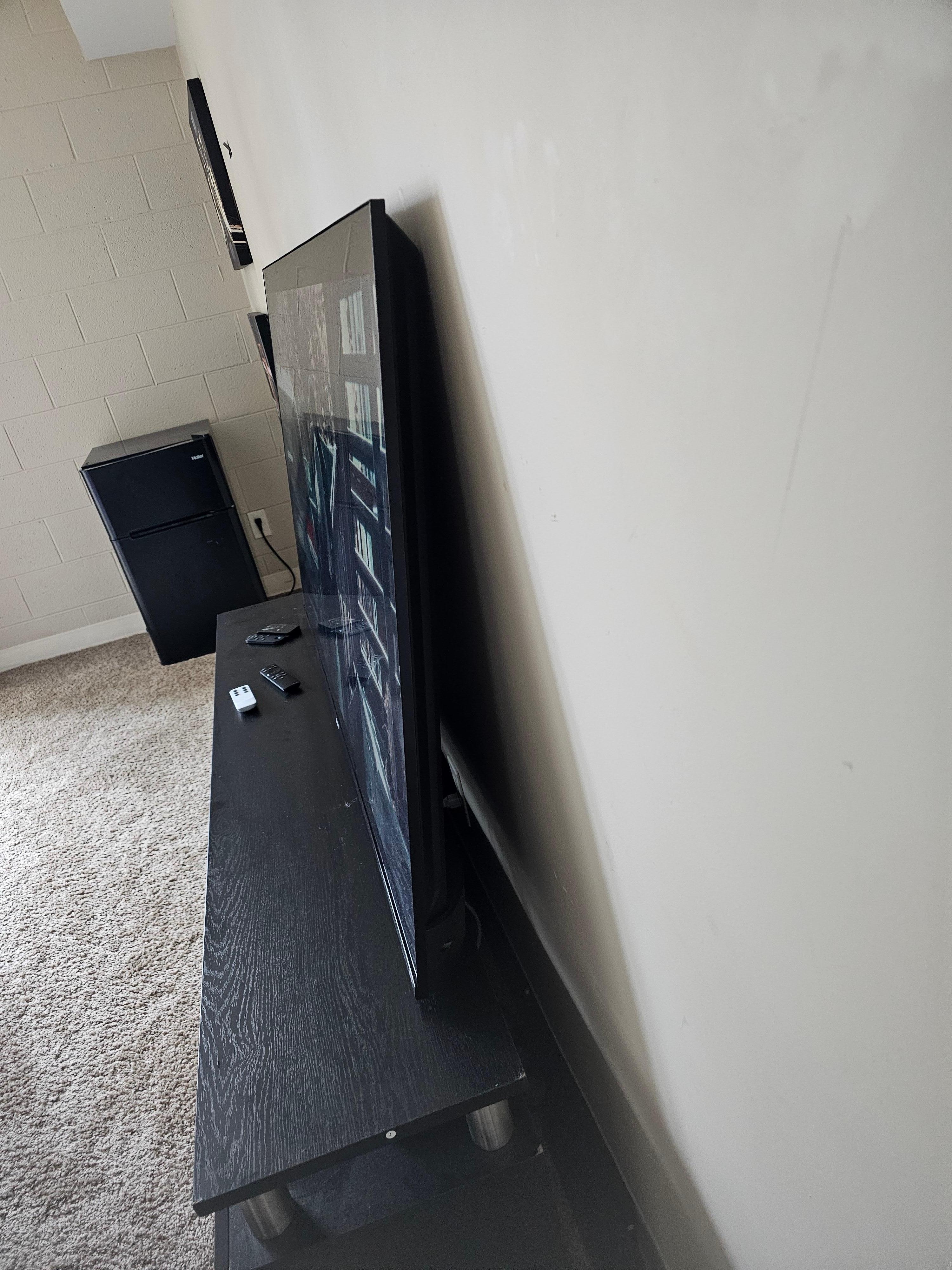 Notice there is nothing holding up this 75" tv. One little bump and hopefully your not in the way.
