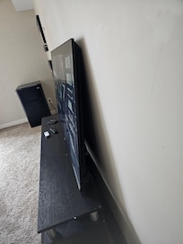Notice there is nothing holding up this 75" tv. One little bump and hopefully your not in the way.