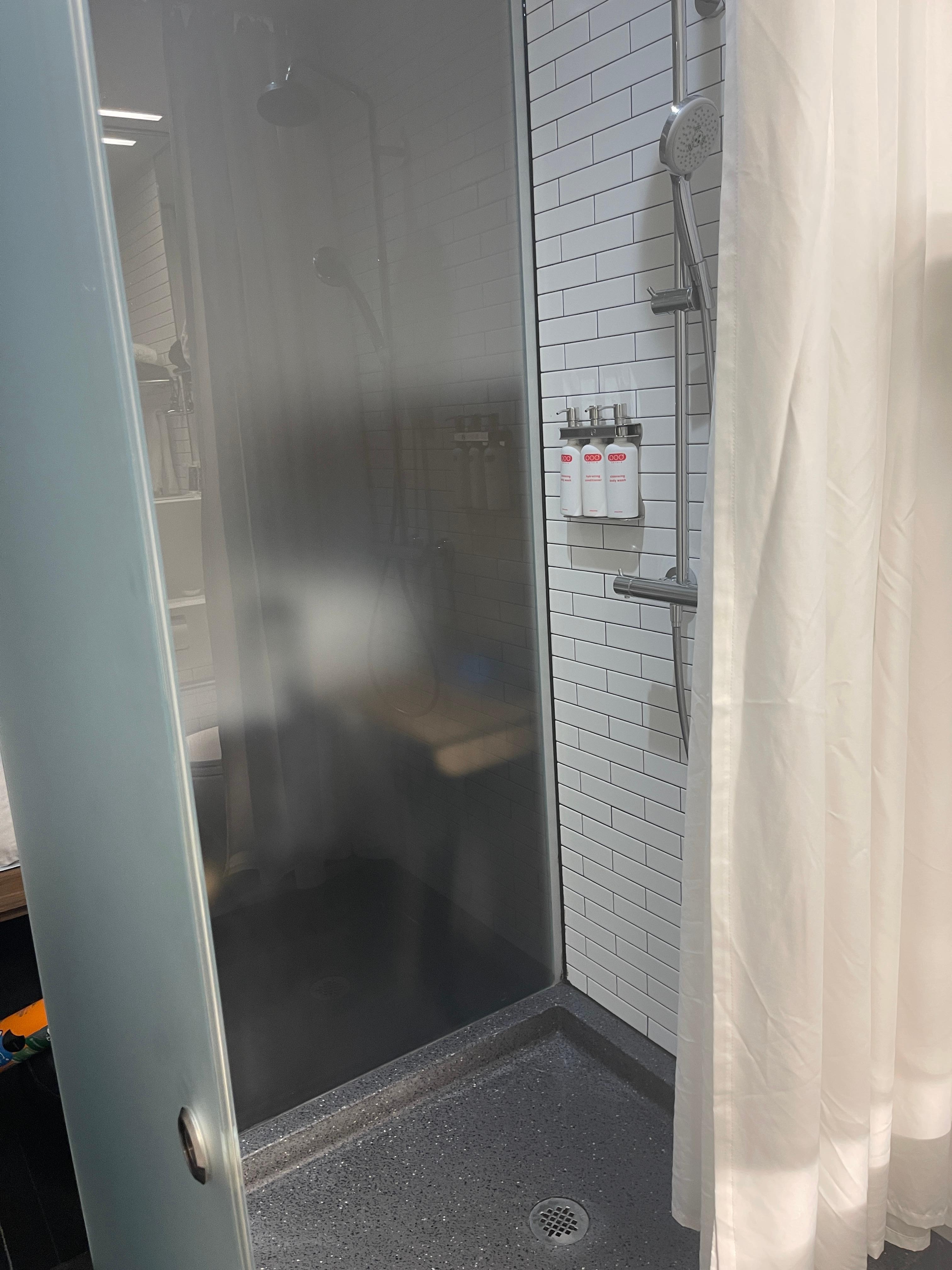 You see the bed on the other side of the shower? 