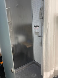 You see the bed on the other side of the shower?