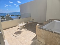 Room with balcony and jacuzzi.