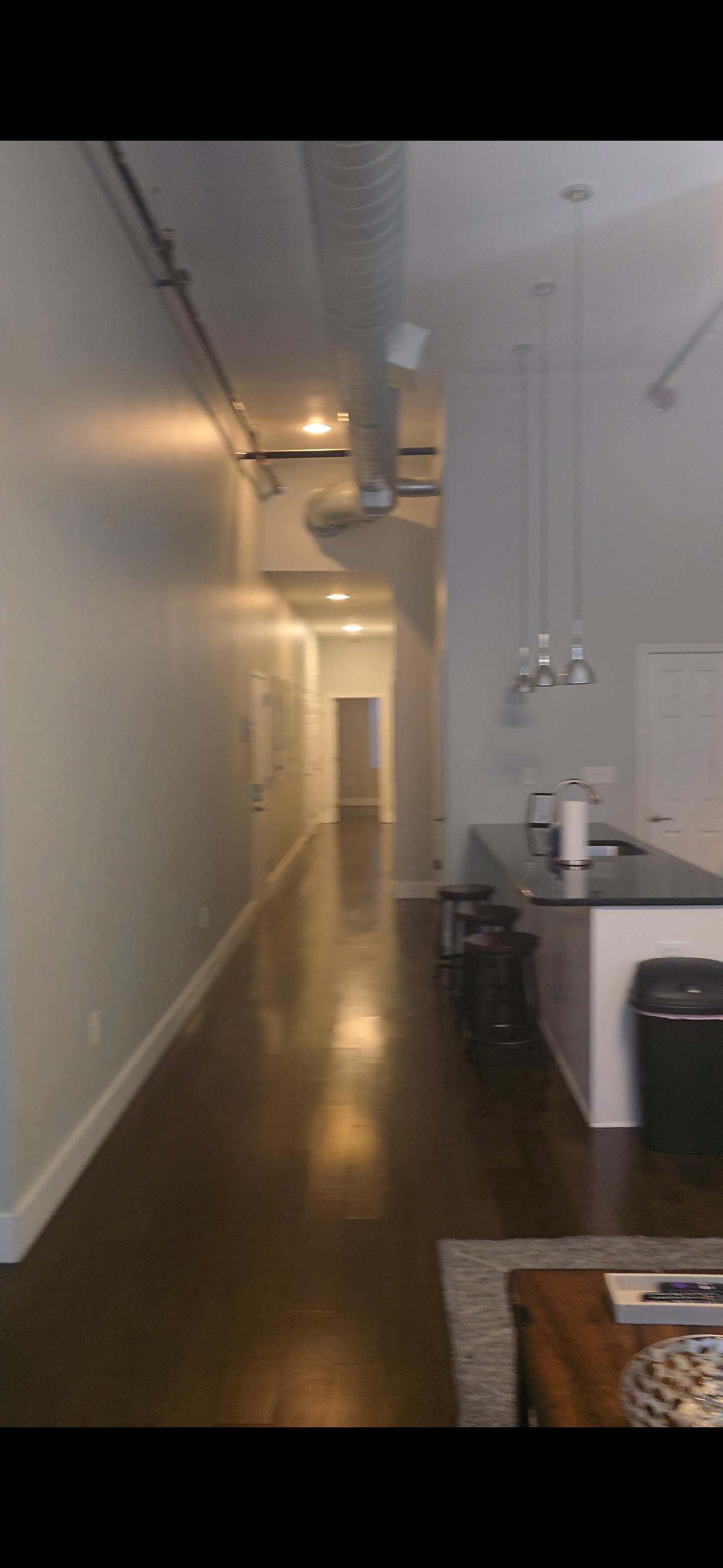 Hallway to both rooms and bathrooms 