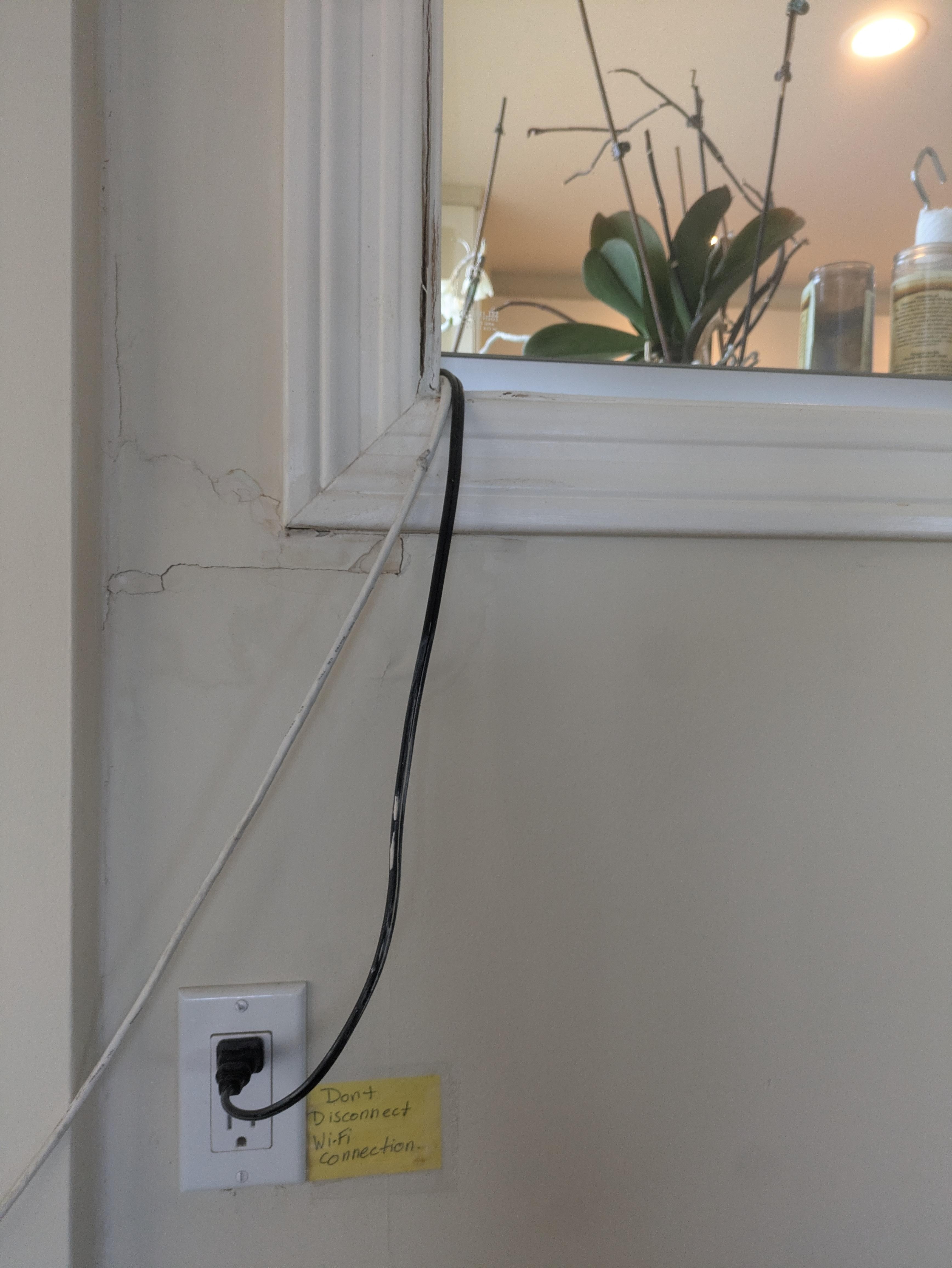 Wi-fi cord running through the kitchen "window" from bedroom