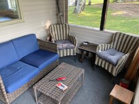 The cozy screened in porch facing the water.