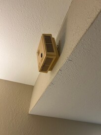The fire alarm was out of service and hanging off of the wall.