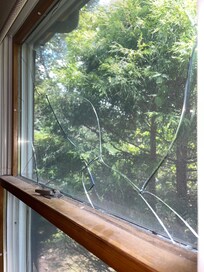 Broken main bedroom window. Barely staying together.