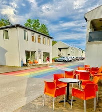 Outside seating on the side and across the street and a view of the limited parking