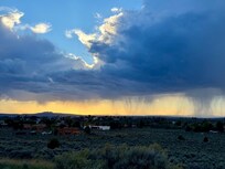 View of surrounding grounds with rain in the distance