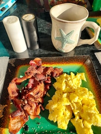 Breakfast on the balcony, served on beautiful dishes provided by the fantastic host.
