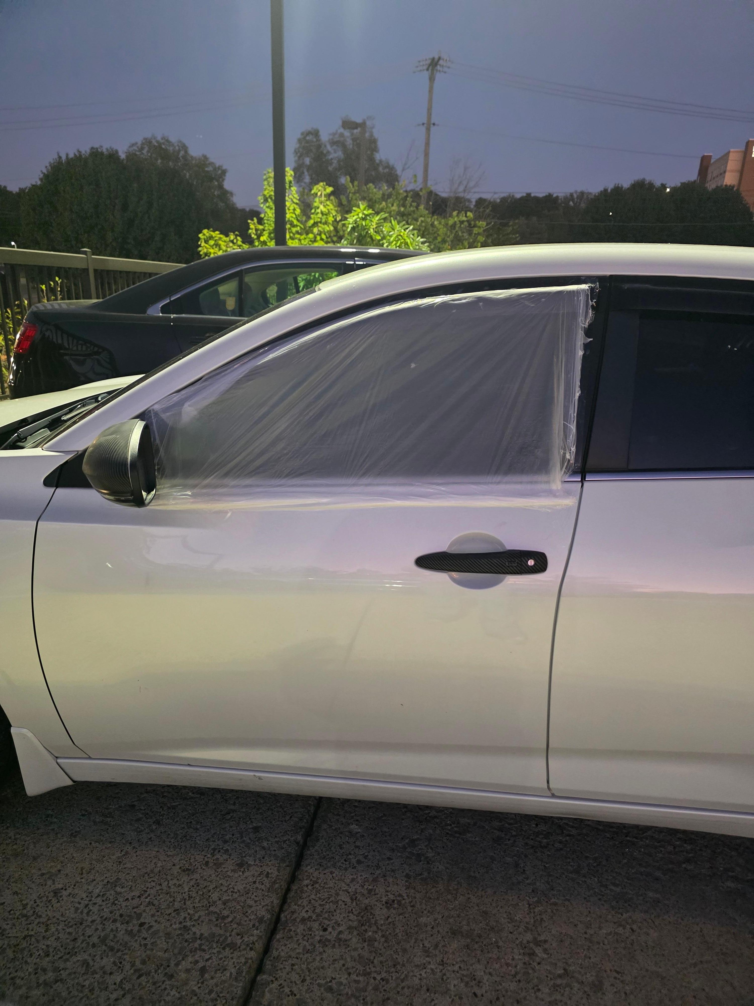 Plastic taped on the window to cover where the thief shattered it while getting in to steal my property. 