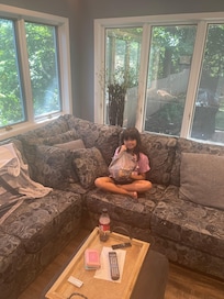 Granddaughter relaxing in the sunroom.