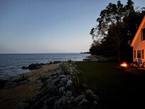 Evening by the fire pit - yes that’s how close the house is to the beach.