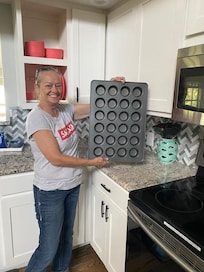 My friend with my cupcake pan I left the first time I was there.