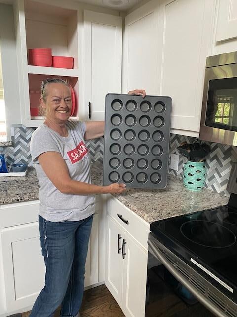 My friend with my cupcake pan I left the first time I was there. 