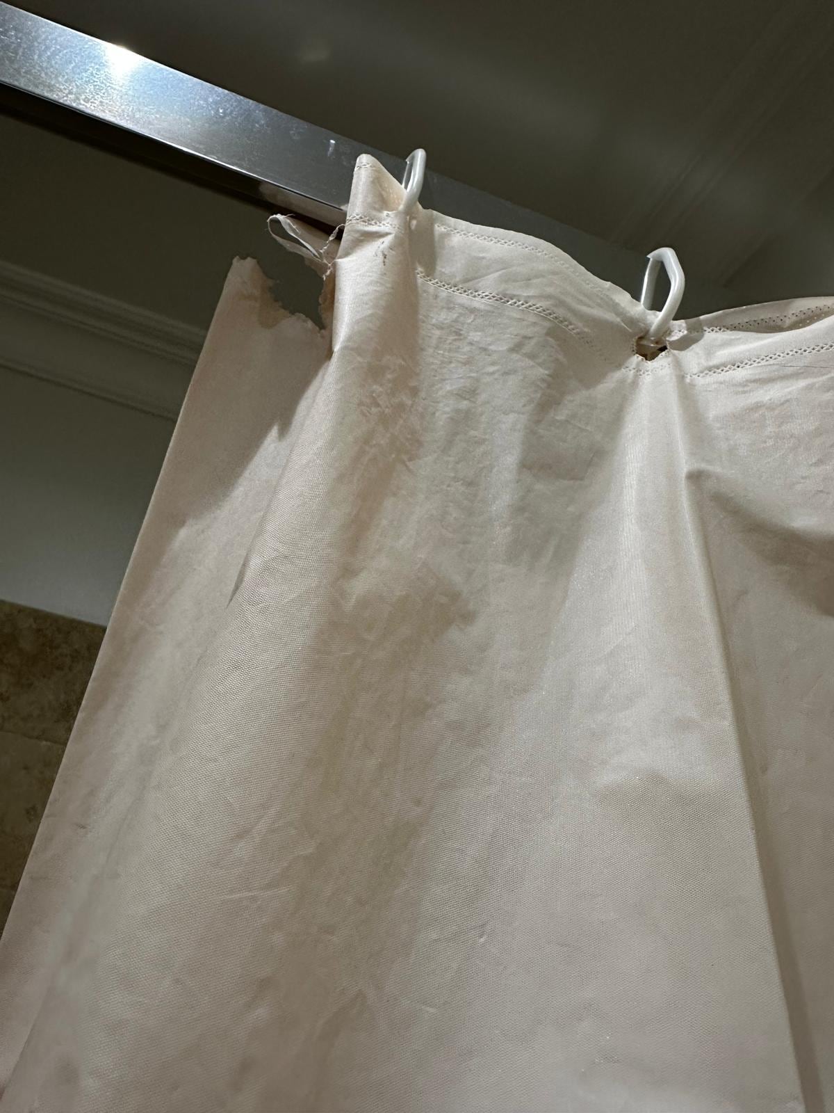unfit and torn shower curtain