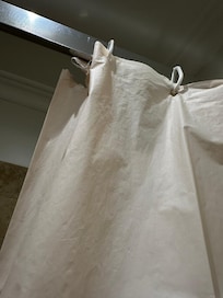 unfit and torn shower curtain