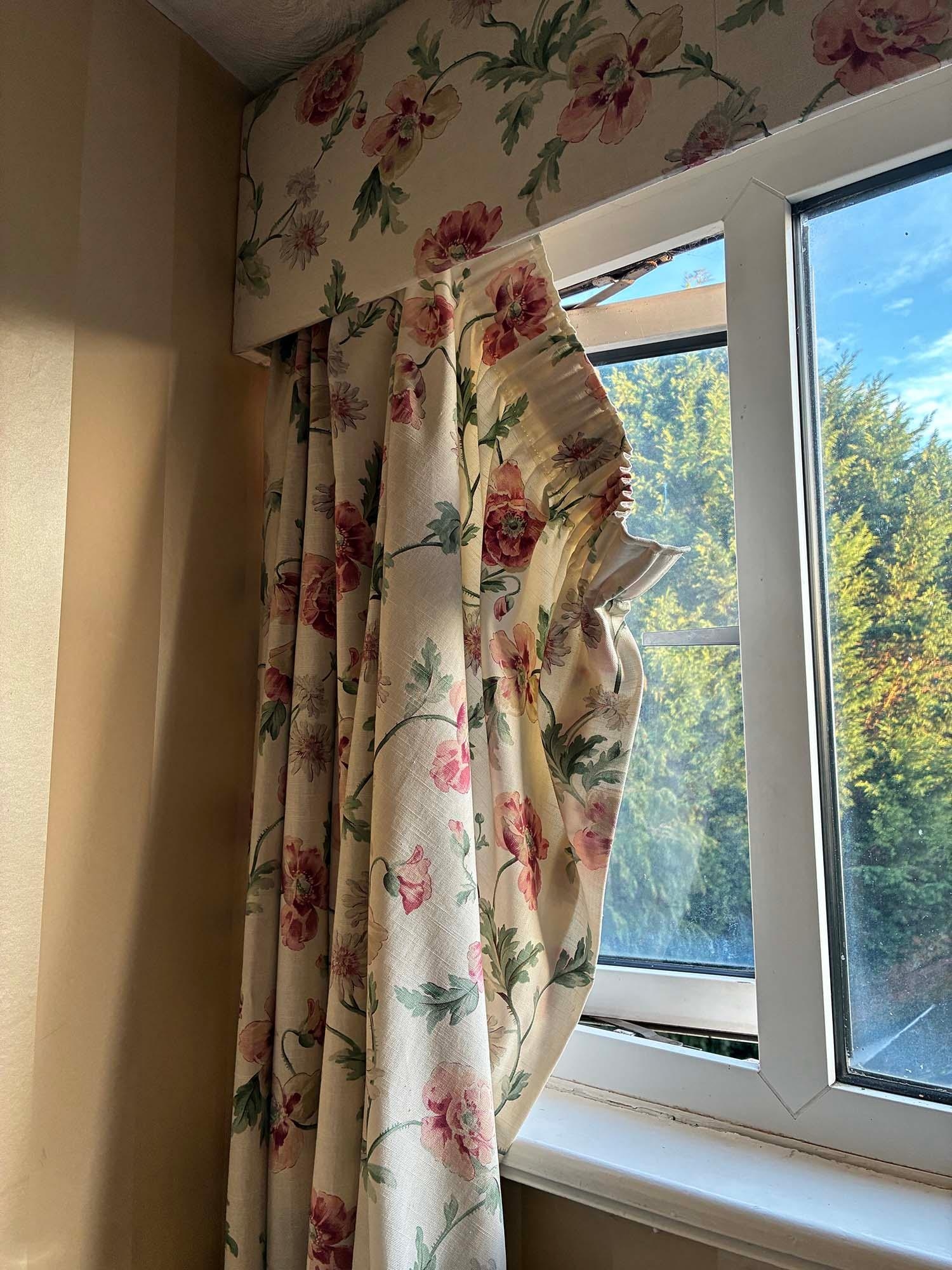 Curtains hanging off rails, I would have re-hung them but was afraid to touch them, given the state of the room.