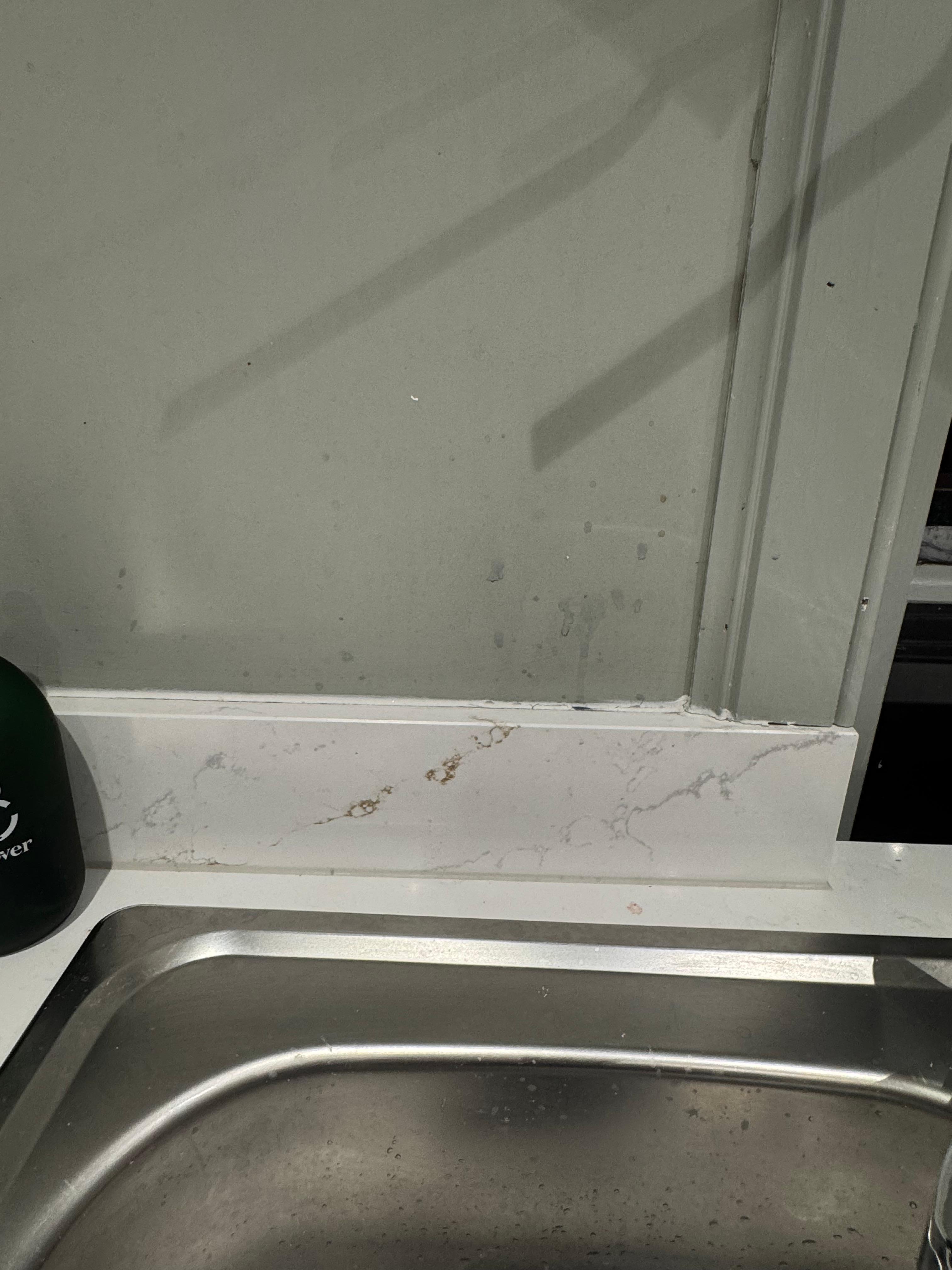 Dirty kitchen counters and walls