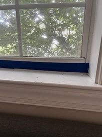 Dirty window sill and the tape was there as the window would not shut