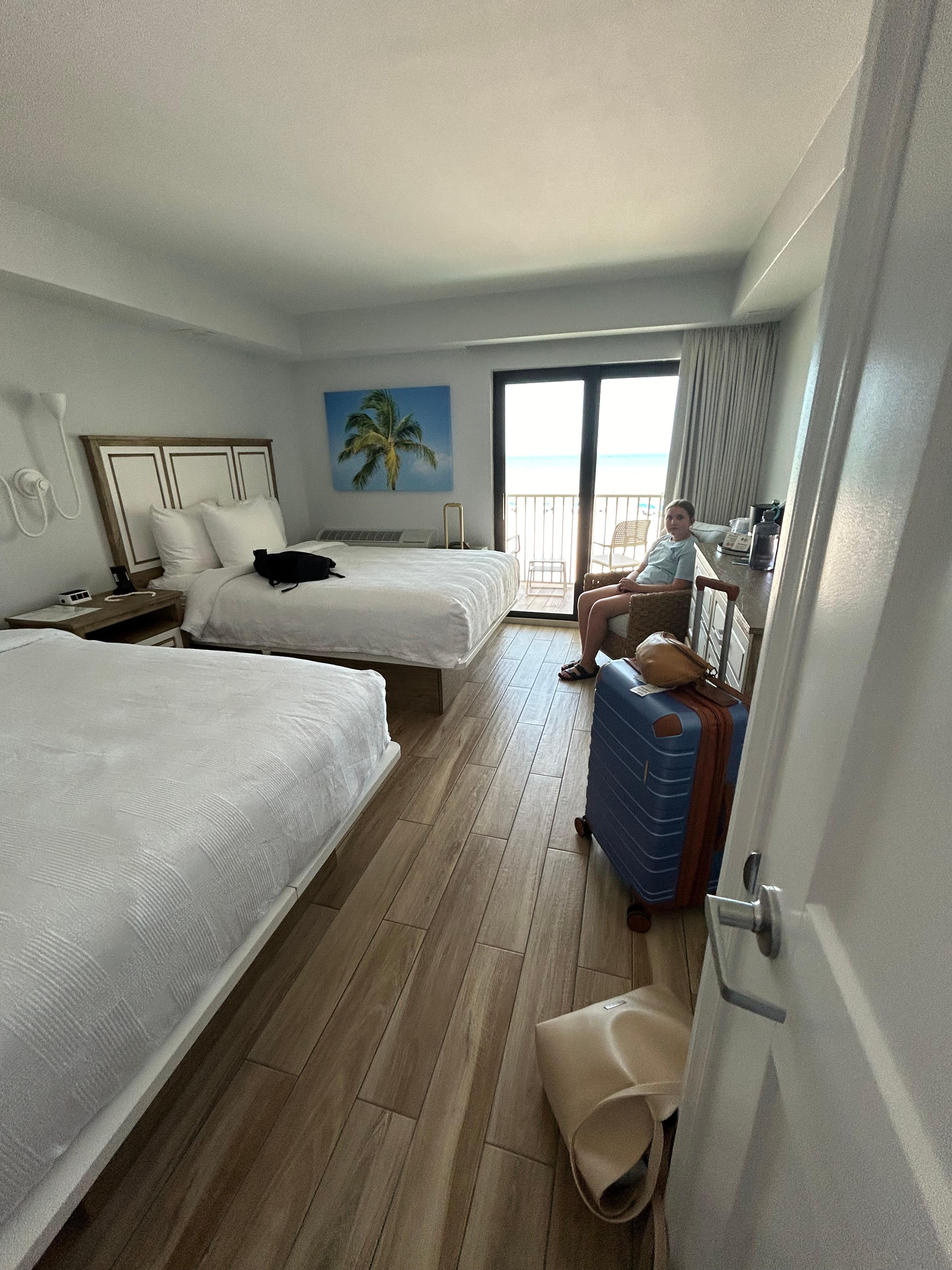 2 double beds, (full size), tv, full size mirror, small closet with ironing board.
