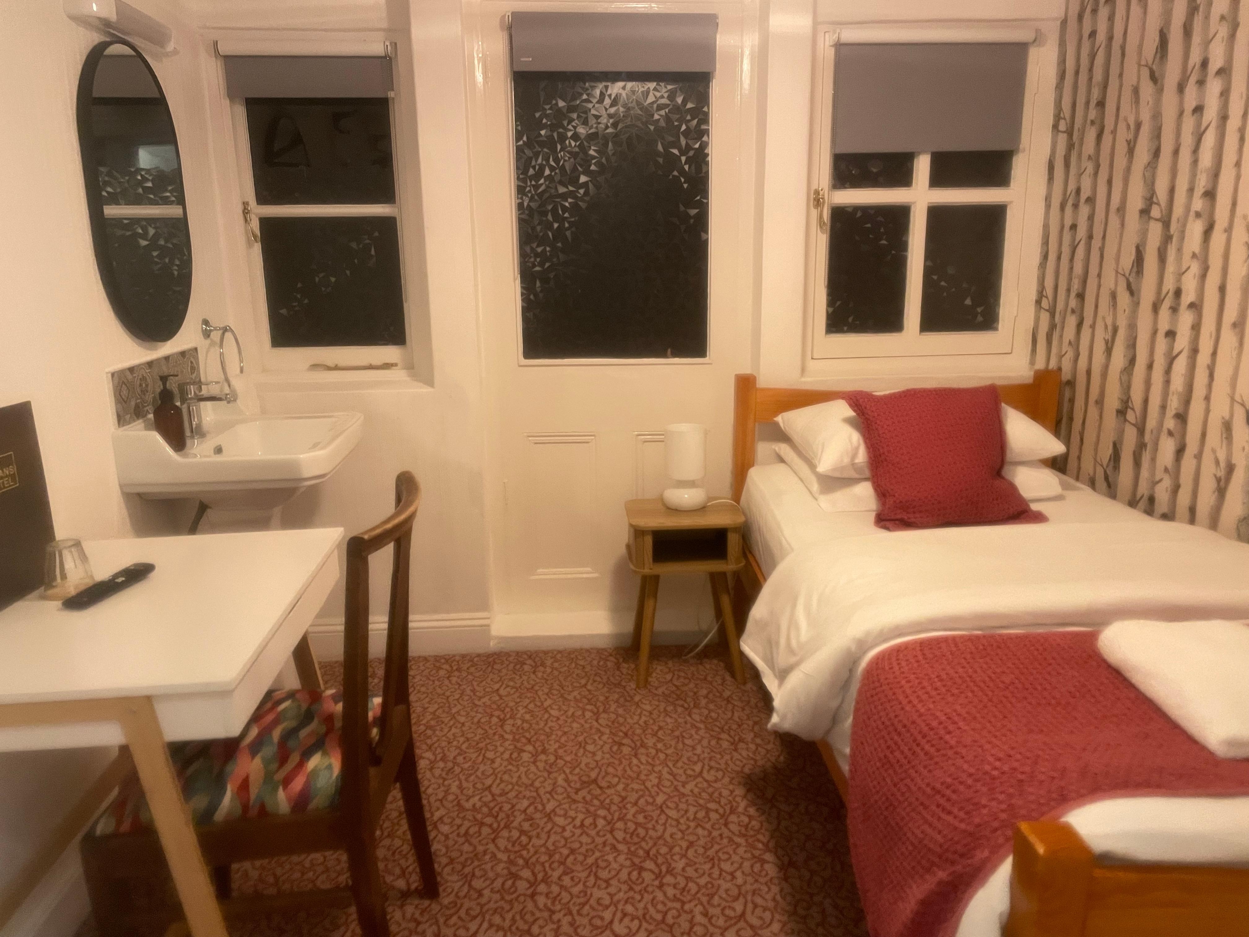 Small but functional, a table lamp and plugs near the bed. 