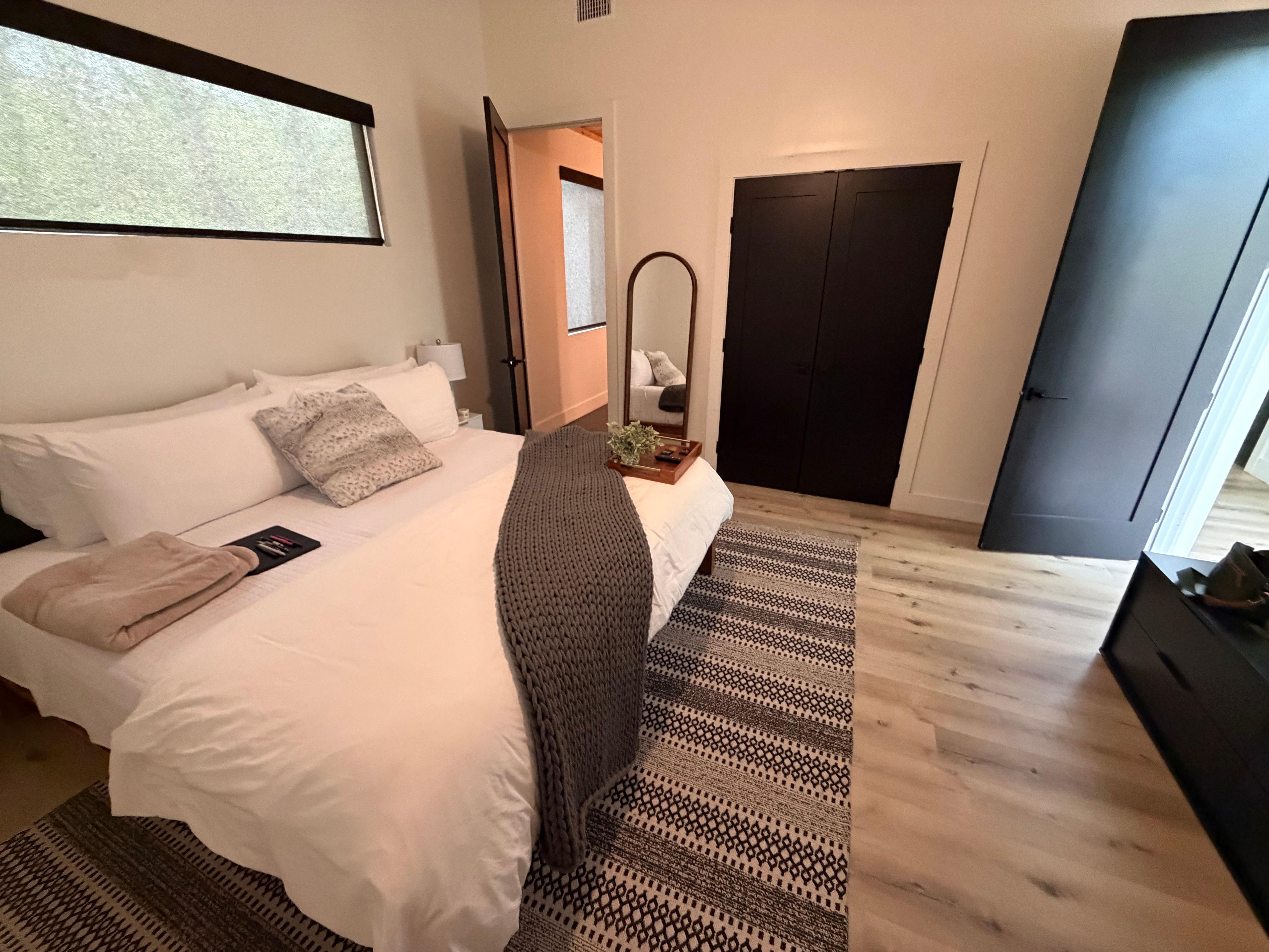 Bedroom closest to entrance. Ignore the gray pillow and brown blanket, those are mine.