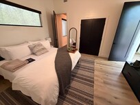 Bedroom closest to entrance. Ignore the gray pillow and brown blanket, those are mine.